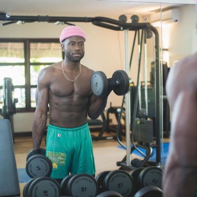 Photo of Sinqua Walls while lifting some weights. 